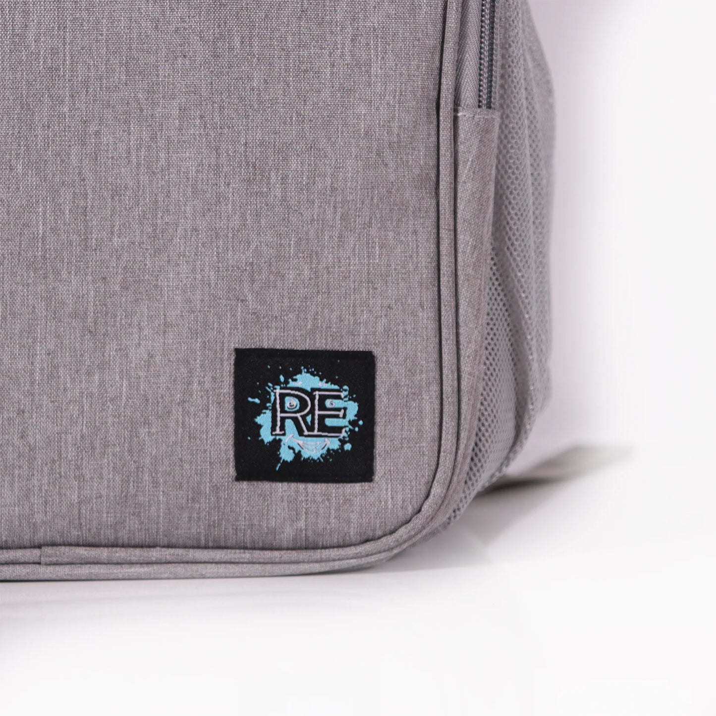 Gray bag with a black label featuring a blue logo on a white background